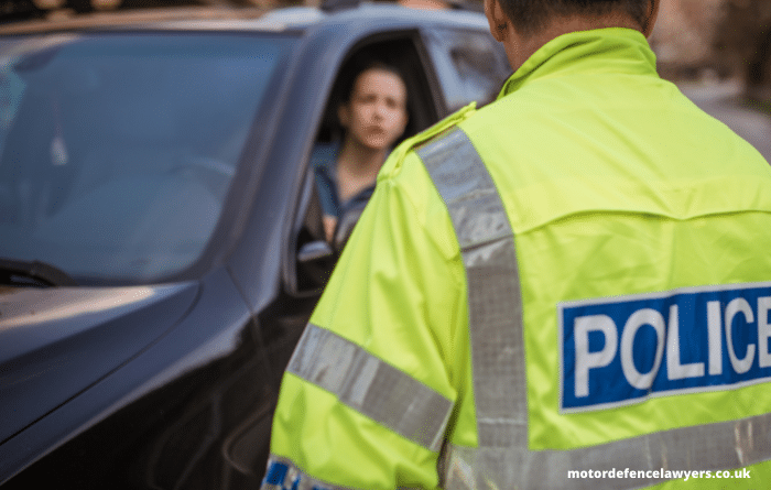 Policeman next to a car that has been pulled over